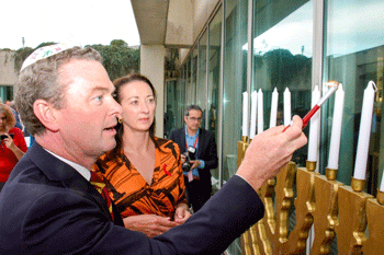 Christopher Pyne lights a menorah earlier this month