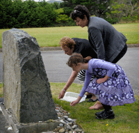 Dame Susan Devoy, New Zealand Race Relations Commissioner, and Mrs Inge Woolf, founding director of the Holocaust Centre of New Zealand, lay stones at the Holocaust Memorial in Wellington’s Jewish Cemetery, together with Mrs Woolf’s grand-daughter Lily-Jane Woolf. (Photo: Photography by Woolf)