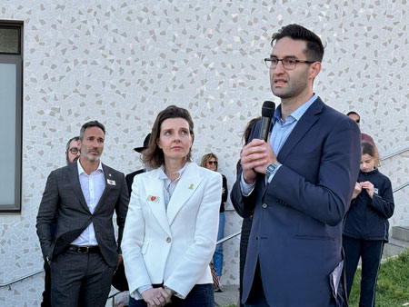 Alex Ryvchin and Allegra Spender listening to Josh Burns