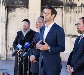 Josh Burns speaking in the ruins of Adass Israel Synagogue