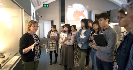 A guide shows a group of students around the museum