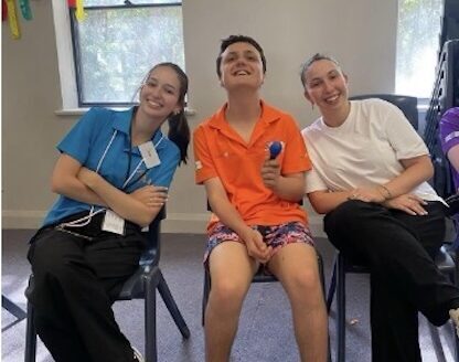 Senior camper with volunteer companions.