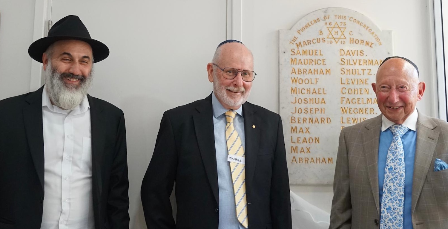 Rabbi Cohavi, Michael Morris in the centre, and Max Lewis, the grandson of Bernard Lewis, unveiling the foundation stone from Bankstown