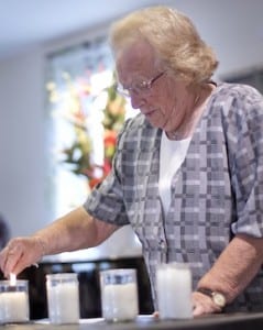 Genia Roth lights a Shoah memorial candle