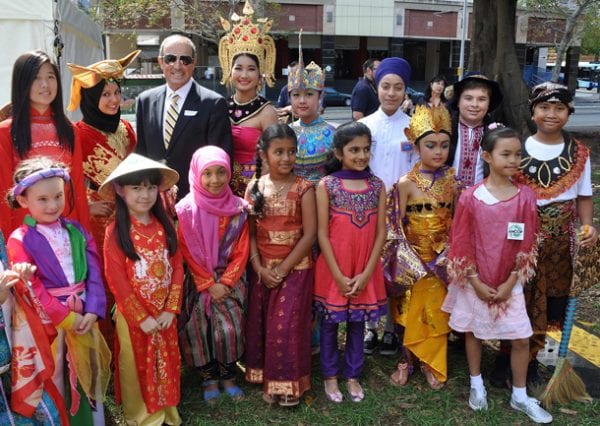 Vic Alhadeff surrounded by children from many cultures