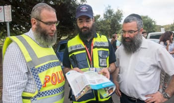 Police chaplain Rabbi Mendel Kastel, Rabbi Yehuda Niasoff and Rabbi Dov Slavin