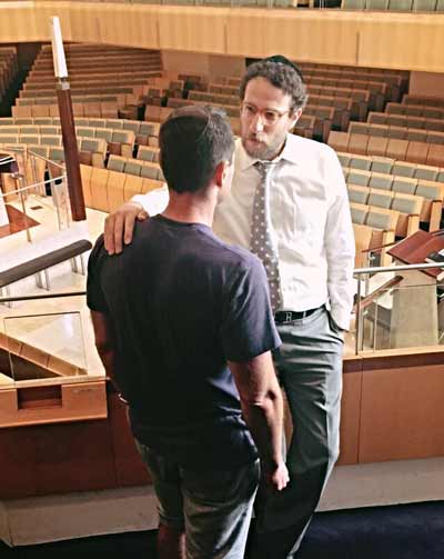 Rabbi Levi Wolff talks to his congregant