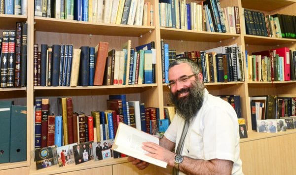 Rabbi Dovid Slavin and some of the 300 books he studied for his thesis Photo Henry Benjamin