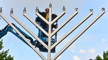 David Clarke lights the Menorah
