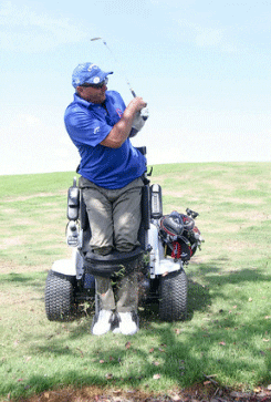 Mechanised golf cart. The buggy raises the golfer for his shot