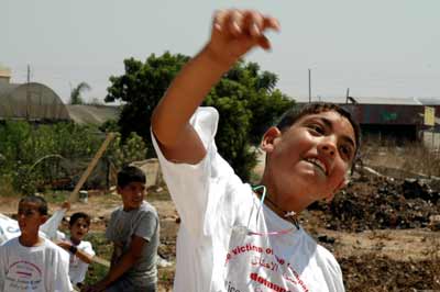 A Palestinian boy throws a stone at Israel's security fence. Credit: Justin McIntosh.